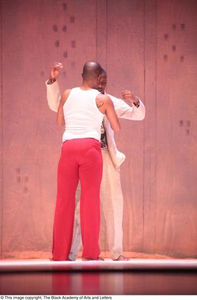 Dancer in red touching groom dancer