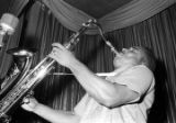 Bobby Moore playing the saxophone on stage at the Laicos Club in Montgomery, Alabama, during a performance by his group, Bobby Moore and the Rhythm Aces.