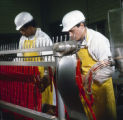 Employees making hot dogs in the R. L. Zeigler Company meat-packing plant, probably in Bessemer, Alabama.