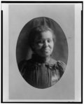 [African American girl, head-and-shoulders portrait, facing front, smiling]