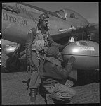 [Tuskegee airman Edward C. Gleed, Lawrence, KS, Class 42-K, with an unidentified crewman adjusting an external seventy-five gallon drop tank on the wing of a P-5/D, "Creamer's Dream." Ramitelli, Italy, March 1945]