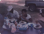 Members of the American Agriculture Movement eating barbecue at a gathering on Oscar Belvin’s farm in Montezuma, Georgia.