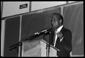 James Baldwin lecturing at UMass Amherst Baldwin standing at a podium with microphones