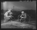 Baltimore, Maryland. Building the SS Frederick Douglass. More than 6,000 Negro shipyard workers are employed at the Bethlehem-Fairfield shipyards where the Liberty ship is being rushed to completion. The noted orator and abolitionist worked as a ship caulker in the vicinity of this yard before he escaped from slavery. Electric Welder Bill Seward and Plate Burner John Smith in Layout Department of way no. 8