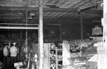 Firemen surveying Bargain Town Market fire damage, Los Angeles, 1971