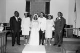 Freddie and Susie Sanders Hubbard standing with their parents at their wedding.