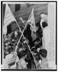 [John Kaspar (below arrow, between flags), addressing group of fellow segregationists protesting school integration, Nashville, Tennessee]