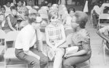 Michael Lottman and Patricia Gorence talking to Sandra Colvin at a meeting of the Montgomery Improvement Association in Montgomery, Alabama.