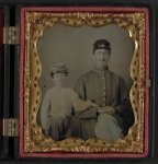 [Unidentified soldier in Union uniform and kepi with unidentified young boy, probably father and son]