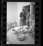 Harriet and Henry Marshall talking as their awaits on table in Los Angeles, Calif., 1968