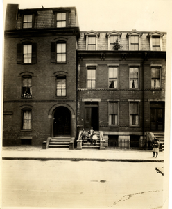 Four boys standing on the front steps of 86 Westminster Street, Roxbury, Mass., May 11, 1927