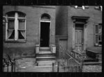 Typical house entrance near Union Station, Washington, D.C. These old brick structures are for the most part inhabited by Negroes. Toilets of these same houses are usually outside and most unsanitary