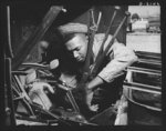Fort Knox. Negro mechanics. Transmission job on an army truck at Fort Knox, Kentucky. This Negro soldier, who serves as truck driver and mechanic, plays an important part in keeping the army's transport fleets in service