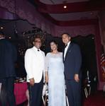 Rev. H. H. Brookins posing with an unidentified couple during a formal event, Los Angeles