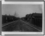 [Unpaved street with houses in Georgia]