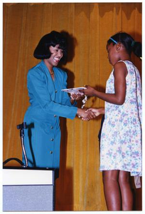 Woman Presenting Gift to Young Girl