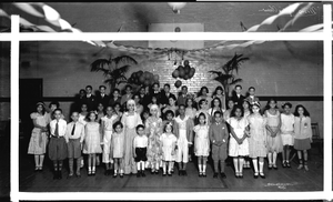 Group at school dance or party, standing in gym, basketball goal above : acetate film photonegative.