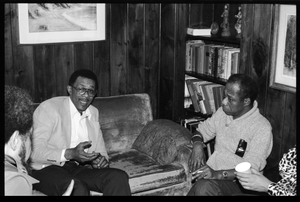 James Baldwin (right, going clockwise) in conversation with Johnnetta Cole (obscured), Michael Thelwell (obscured), and David Graham Du Bois, at the book party for Robert H. Abel