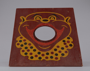 Bean bag toss board depicting a caricature of a clown