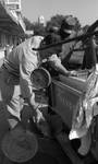 African American man buying fish from white man: Image 3