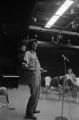 Etheridge Knight: Oxford, Miss. Knight performing at microphone in front of small audience (EKP 3-79-12/11 #296)