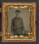 [Unidentified young soldier in Union uniform with revolver and knife in belt standing with a cigar in his mouth]