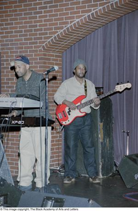 Bassist and keyboardist performing onstage