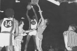 Ric Cobb attempts to score against Drake while Dean Meminger looks on, 1970