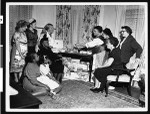 Charlotta Bass shows her guests souvenirs from her trip to Europe, after circa Sept. 1950, Los Angeles