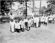 Celebrations around the awarding of a 1943 Army Navy E Award to the Avondale Mills, Sylacauga, Alabama. This photograph is of a group of very young African-American children