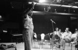 Etheridge Knight: Oxford, Miss. Knight performing at microphone in front of small audience (EKP 3-79-12/11 #296)