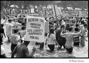 Splashing in the Reflecting Pond during the Poor Peoples’ Campaign Solidarity Day Protesters holding signs, one reading 'Redeem the American promise: life, liberty, happiness for all"