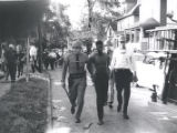 Police escort man down street after riot, Rochester, NY, 1964