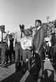 Thumbnail for Muhammad Ali shaking hands with Al Dixon, a disc jockey for radio station WXBI, on the football field during homecoming activities for Alabama State College on Thanksgiving Day in Montgomery, Alabama.