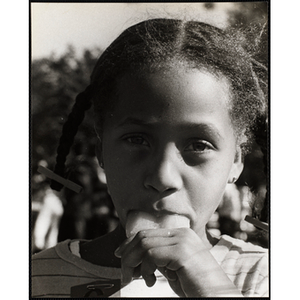 Close-up of an African American girl from the Roxbury Boys' Club sticking her tongue out