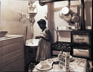 Girl brushing her teeth in kitchen : photonegatives.