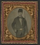 Thumbnail for [Unidentified soldier in Union uniform and forage cap reading "PIKE" with cigar in mouth and holding musket and sword]