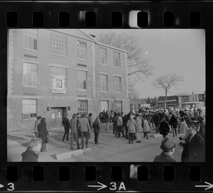 White students parade with placards outside Ford Hall at Brandeis University