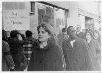 Mississippi State Sovereignty Commission photograph of unidentified demonstrators standing in front of a Western Union storefront during an Anti-Vietnam War demonstration protesting Secretary of Defense Robert McNamara's visit to Jackson, Mississippi, 1967 February 24