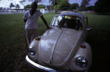 Man leaning on Volkswagen automobile