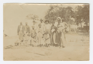 Photograph of men, women, and children in a yard