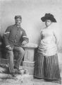 Studio portrait of African American officer and woman, Company D, 25th United States Infantry Regiment "Buffalo Soldiers", Fort Custer, Montana, ca. 1889