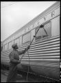 Worker washing windows of Zephyr car, 14th Street passenger yards, Chicago, May 1948