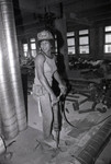 Women construction worker posing at a Community Redevelopment Agency project site, Los Angeles, 1981