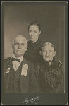 [Unidentified Civil War veteran wearing United Confederate Veterans Joseph E. Johnston Camp No. 1 ribbon with his wife and daughter]