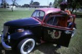 Man leaning on vintage car