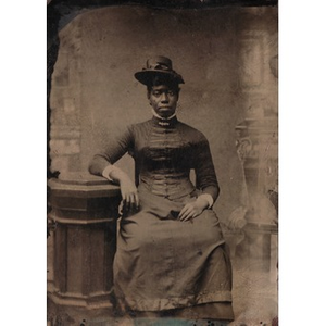 Thumbnail for An African American woman sitting by a pedestal