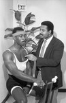 Baldwin Hills Medical staff member listening to a man's heart rate , Los Angeles, 1986