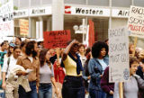 Bakke Decision Protest depicting people marching and holding protest signs in Seattle, Washington, 1977