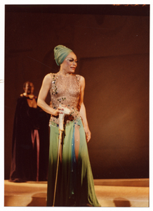 Performance photo of Eartha Kitt (green turban), a man is in the background]. [color photoprint